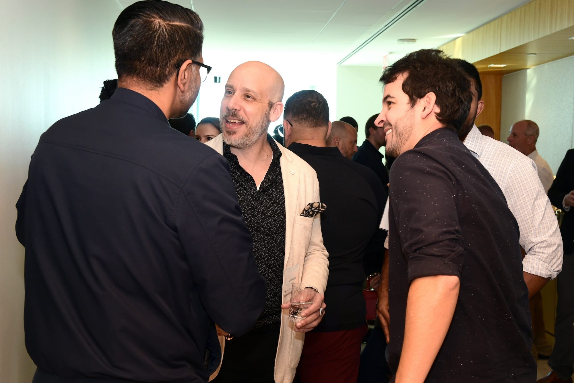 Attendees at a Forum event discussing business.