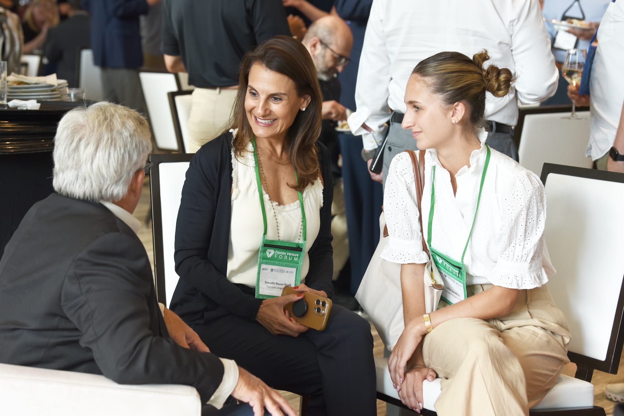 Attendees at a Forum event discussing business.